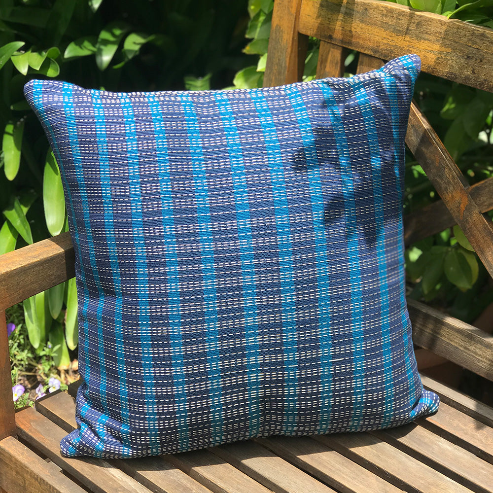 Phoebe cushion. Blue and navy blue stripes made with 100% organic cotton and natural dyes. Designed by Woven. Handmade in Guatemala.