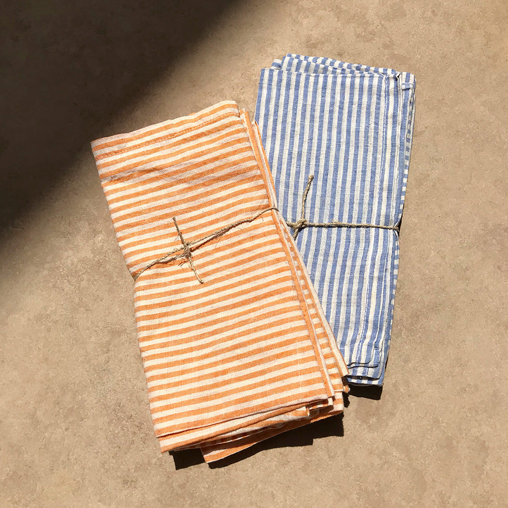 Orange and blue striped cotton table napkins. Designed by Woven. Handmade in India.