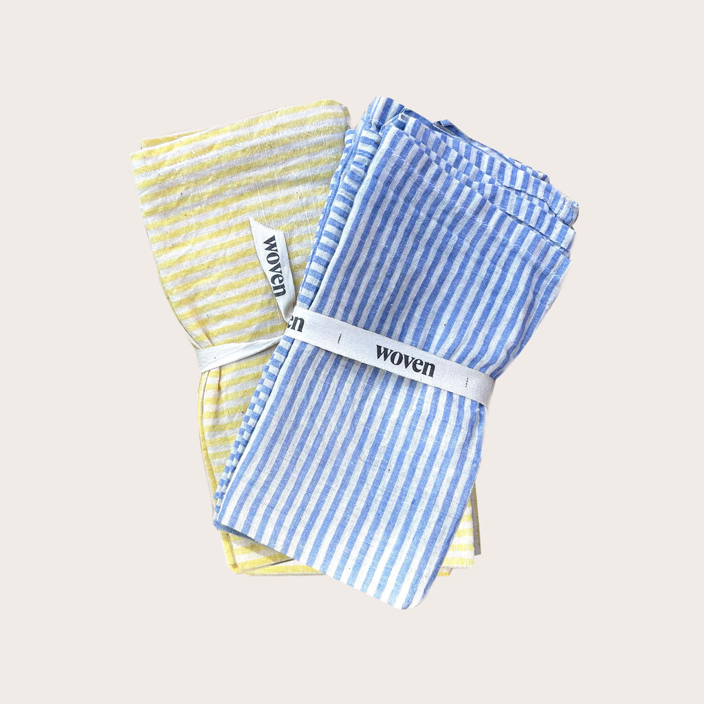 Yellow and blue striped cotton table napkins. Designed by Woven. Handmade in India.