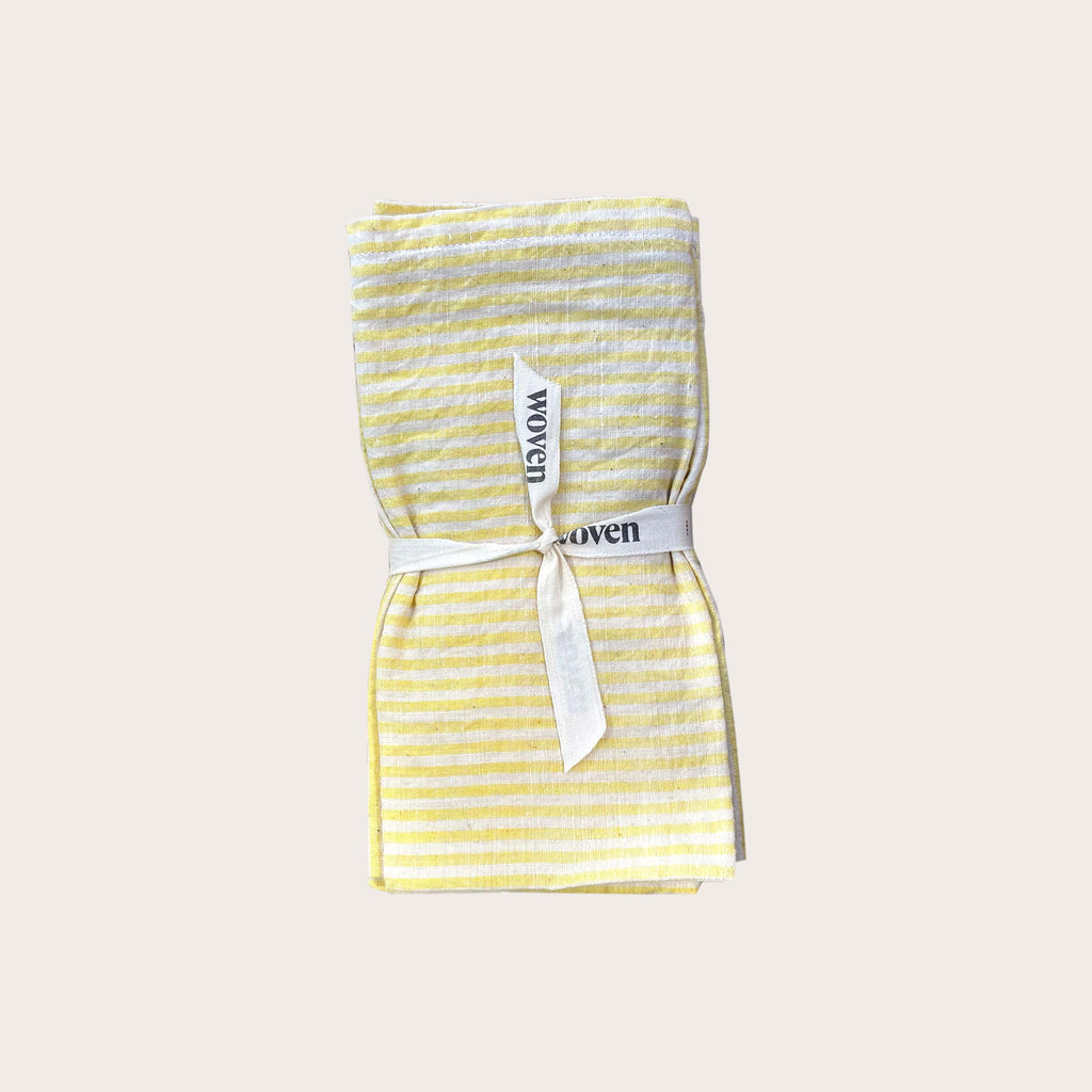 Yellow striped cotton table napkins. Designed by Woven. Handmade in India.