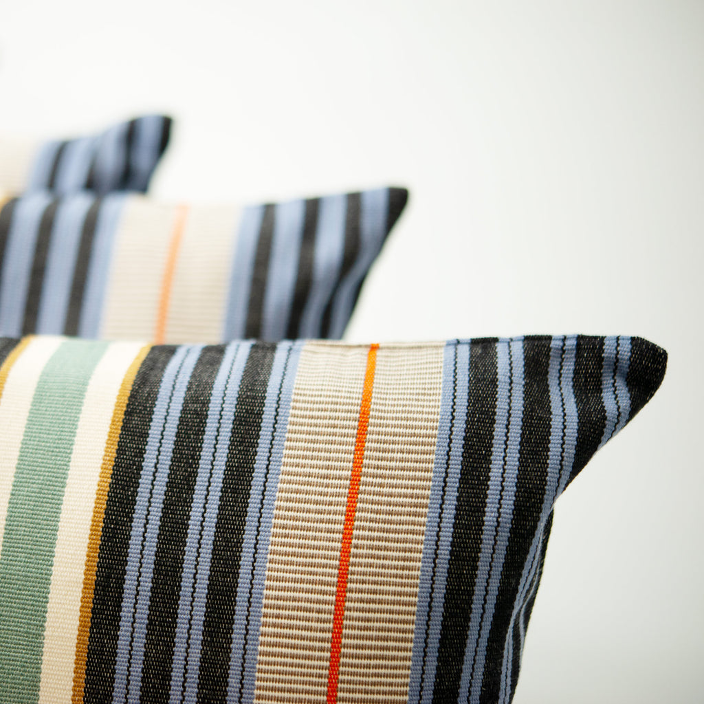 Filip cushion with multi coloured stripes, made with 100% organic cotton. Designed by Woven. Handmade in Guatemala.