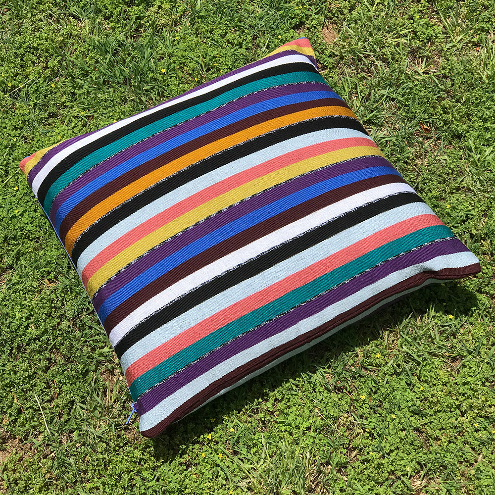 Chloe Cushion. Multi coloured stripes made with 100% organic cotton. Designed by Woven. Handmade in Guatemala.